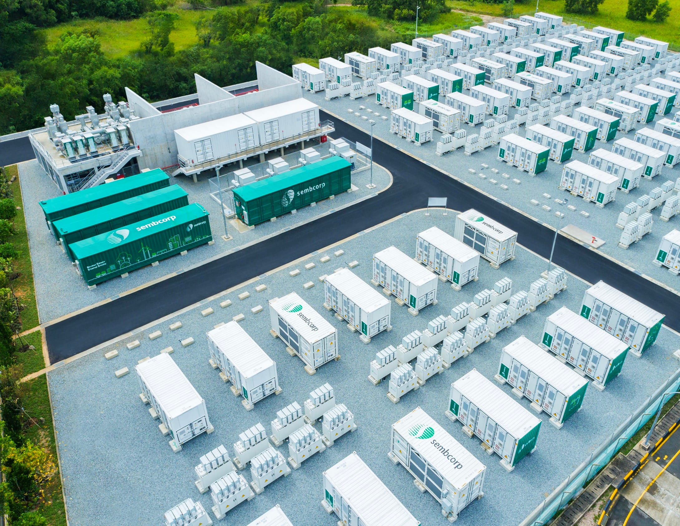 Aerial view of Sembcorp battery energy storage system. Rows of containers on a gravel surface.